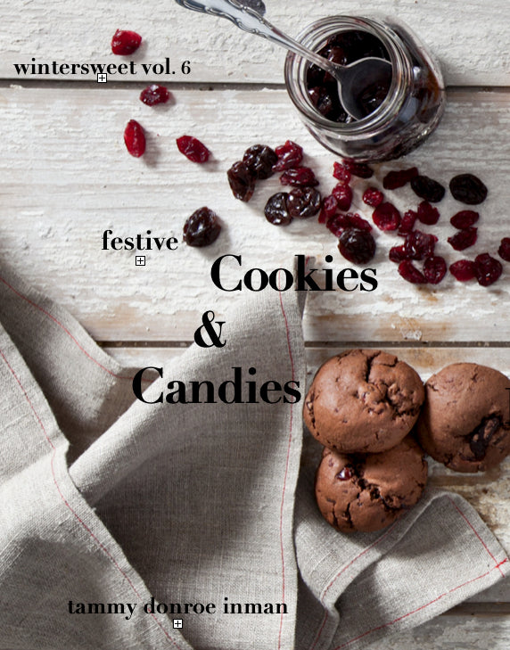 Book cover of 'Wintersweet Vol. 6: Festive Cookies & Candies' by Tammy Donroe Inman with cookies and candies on a wooden surface.